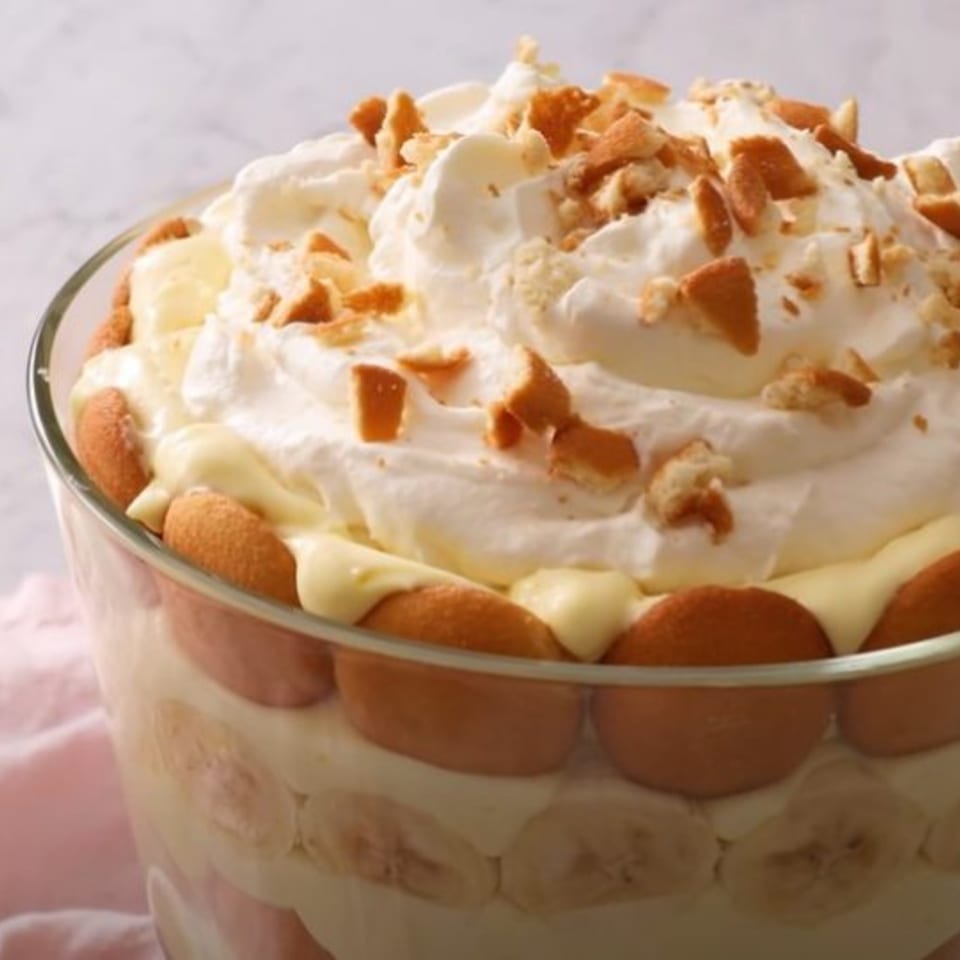 Close-up of William's Barbecue banana pudding with whipped cream and vanilla wafer crumbles.